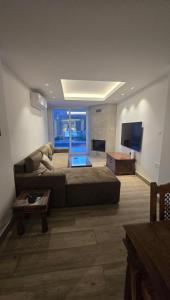 a large living room with a couch and a television at Ephrosinis Cottage in Pedoulas