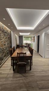 a dining room with a wooden table and chairs at Ephrosinis Cottage in Pedoulas