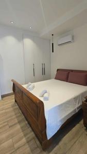 a bedroom with a large bed with two towels on it at Ephrosinis Cottage in Pedoulas