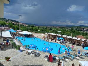 a group of people in a large swimming pool at Hotel Sunrise and Spa in Čiflik