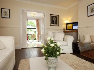 a living room with white furniture and a vase of flowers at 2 Bed in Richmond oc-g0116 in Hutton Magna