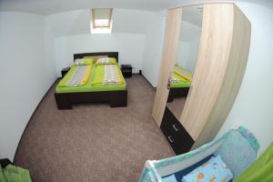 a bedroom with two beds and a mirror at casa Dany&Ady in Râşnov +23 photos