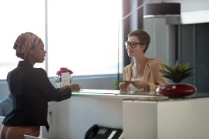 a woman standing in front of a counter in an office at St. Petersburg Marriott Clearwater in St. Petersburg