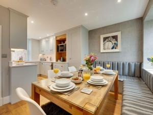 a dining room and kitchen with a table and chairs at 3 Bed in Beadnell oc-cn113 in Beadnell