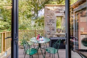 a patio with a table and chairs on a deck at 2 Bed in Melkridge oc-b32221 in Haltwhistle