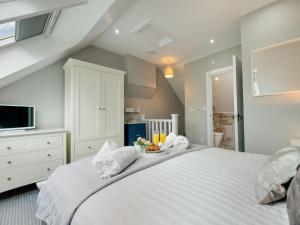 a bedroom with a large white bed with towels on it at 3 Bed in Beadnell oc-cn113 in Beadnell