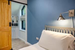 ein blaues Schlafzimmer mit einem Bett und einer Lampe in der Unterkunft 2 Bed in Melkridge oc-b32221 in Haltwhistle