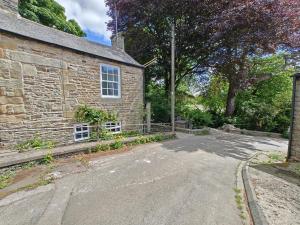 an empty road next to a stone building at 2 Bed in Melkridge oc-b32221 in Haltwhistle