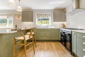 a kitchen with green cabinets and a counter at 3 Bed in Llanfyllin oc-i32566 in Llanfyllin