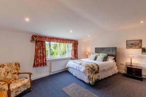 een slaapkamer met een bed, een raam en een stoel bij 1 Bed in Catton oc-b31984 in Catton