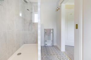 a white bathroom with a shower and a tub at 3 Bed in Llanfyllin oc-i32566 in Llanfyllin +38 photos