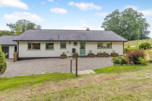 a house with a gravel driveway in front of it at 3 Bed in Llanfyllin oc-i32566 in Llanfyllin