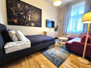 a living room with a couch and a tv at Apartamenty Stary Rzeszów in Rzeszów