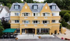 an aerial view of a yellow building at Earls Court House in Killarney