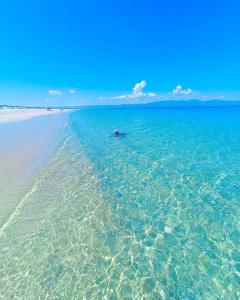 a person in a boat in the water on a beach at Grand Ocean View Suite with Private Pool in La Paz