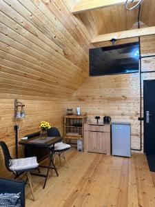 a kitchen with wooden walls and a table and chairs at Debed View in Debed