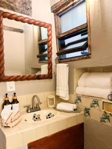 a bathroom with a sink and a mirror at Ombligo Connection House in Valle de Bravo +54 photos