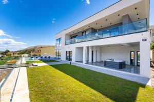 una grande casa bianca con cortile di Villa Prestige a Pag