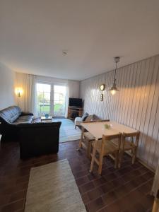 a living room with a couch and a table at Auszeit am Feldrand in Lensahn