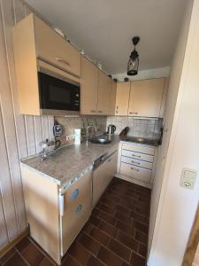 a small kitchen with a sink and a counter at Auszeit am Feldrand in Lensahn