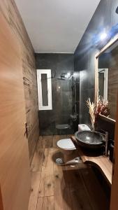 a bathroom with a sink and a toilet and a mirror at Savvas Apartment in Tolo +130 photos