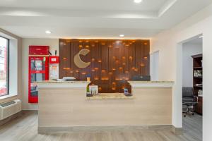 a restaurant with a counter with a sign on the wall at Comfort Inn in Staten Island