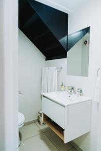a bathroom with a white sink and a mirror at Modern Nest in Sandton +11 photos