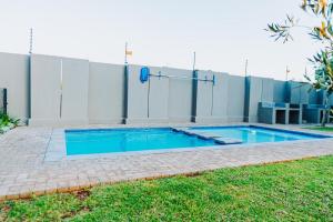 a swimming pool in front of a building at Modern Nest in Sandton