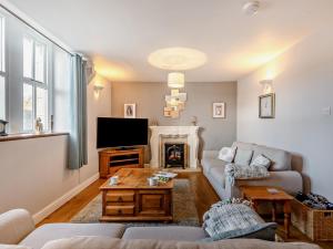 a living room with a couch and a fireplace at 2 Bed in Ambleside oc-95914 in Hawkshead