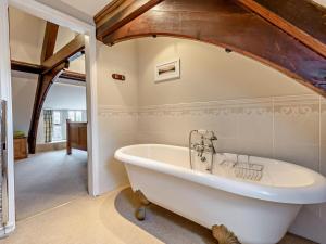 a large white bath tub in a bathroom at 2 Bed in Ambleside oc-95914 in Hawkshead +15 photos
