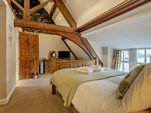 a bedroom with a large bed and a tv at 2 Bed in Ambleside oc-95914 in Hawkshead