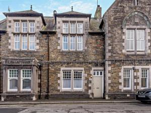 an old brick building with a car parked in front at 2 Bed in Ambleside oc-95914 in Hawkshead