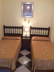 a hotel room with two beds and a window at Ca Bienvenida in Miramar