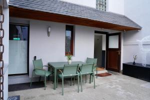 a green table and chairs on a patio at Altstadt Apartment Deluxe 2 in Haltern