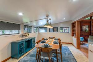 a kitchen and dining room with a table and chairs at Serenity Grove in Fort Bragg