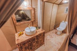 a bathroom with a sink and a toilet at Luxury Camp Sahara in Merzouga