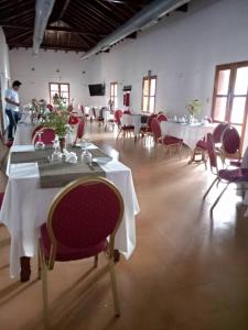 a dining room with tables and chairs in a building at Hotel Saylu by Venetur in Río Caribe