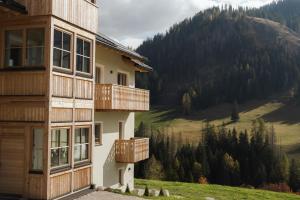 a building with wooden balconies and a view of a mountain at Ciasa Bel Marin in La Villa