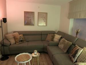 a living room with a couch and a table at Ons huisje in Schoot in Budel-Schoot