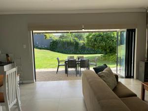 a living room with a couch and a table and chairs at Clarens Escape (Unit 2) in Clarens