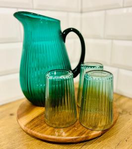 a green vase and two glasses on a cutting board at Ons huisje in Schoot in Budel-Schoot +42 photos