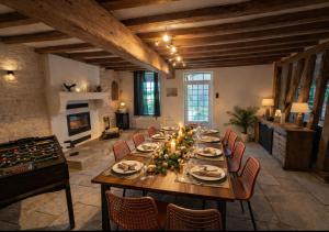 une grande salle à manger avec une grande table et des chaises dans l'établissement Le terroir des sens, à Corgengoux