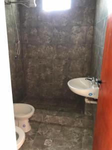 a bathroom with two toilets and a sink at Alojamiento La Mamu 1 in Paso de la Patria +9 photos