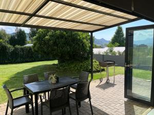 a patio with a wooden pergola and a table and chairs at Clarens Escape (Unit 2) in Clarens