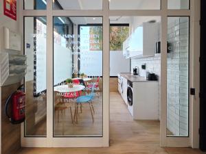 a kitchen with a table and a dining room at Bilbao ROOMS & KITCHEN Altube in Bilbao