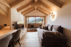 a living room with a couch and a table at Ciasa Bel Marin in La Villa