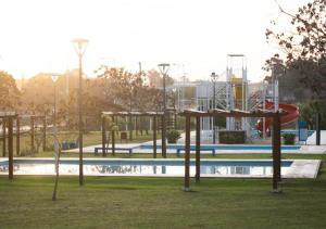 an empty park with a playground with a pool at Bungalow El Pini in Chajarí +2 photos