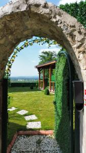 an archway leading to a garden with a gazebo at YAKUT bungalow in Akyazı +5 photos