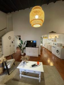 a living room with a table and a living room with a kitchen at Title e Title - Alentejo in Monforte