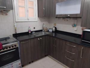a small kitchen with a sink and a stove at مصر مدينة الشيخ زايد in Sheikh Zayed